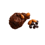 Small pile of Dark Chocolate Chips and whole Dry Roasted Almonds sitting next to a smear of Chocolate Almond Butter.