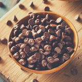 Timber bowl full of Callebaut Milk Chocolate Callets, sitting on timber board.