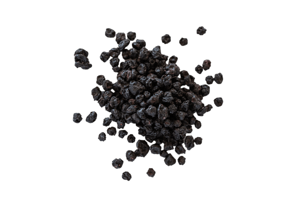 Small pile and scattering of Dried Blueberries.