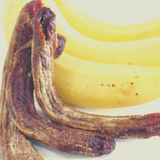 Close up of Australian Dried Bananas sitting next to fresh, yellow Cavendish Bananas.