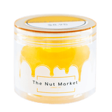 Side on view of Nut Market jar with Glace Pineapple inside.
