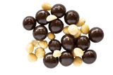 Pile of Dark Chocolate Macadamias with raw macadamia nuts scattered amongst them.