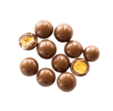 Chocolate Malt Balls scattered with some chopped open to expose crispy centre.