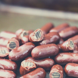 Close up of bulk Bullets Milk Chocolate Coated.
