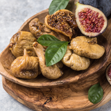 Timber bowl full of organic dried figs and fresh figs.