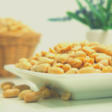 Peanuts Dry Roasted sitting on square white plate.