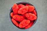 Small round bowl of Strawberry Clouds on light grey background.