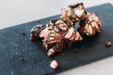 Chunk of Rocky Road Milk Chocolate on slate board.