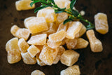 Small pile of Crystallised Ginger on dark background.