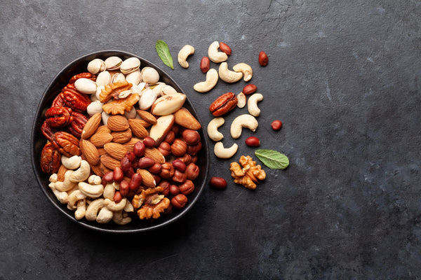 Various nuts in a bowl on a dark background