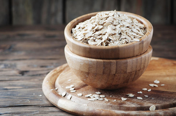 Wooden bowl filled with rolled oats