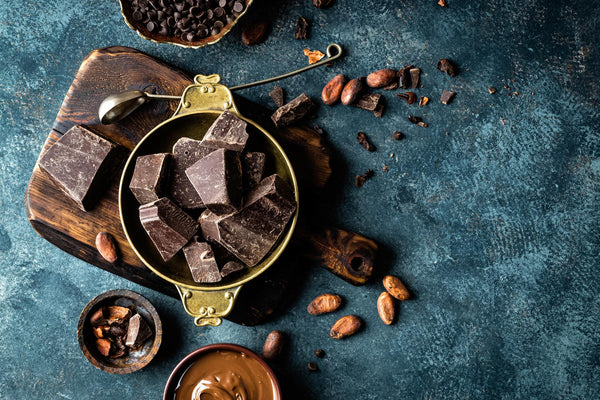 A top down view of a bowl full of dark chocolate.