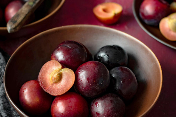 A bowl full of plums.