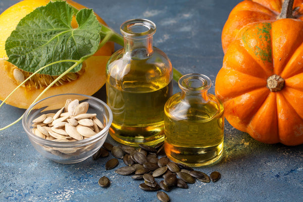 Pumpkin seed oil and fresh pumpkins.