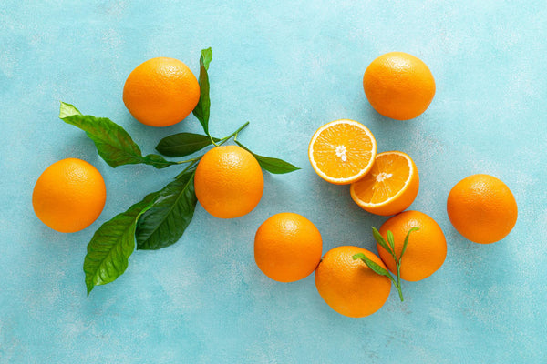Oranges containing Vitamin C on a blue background