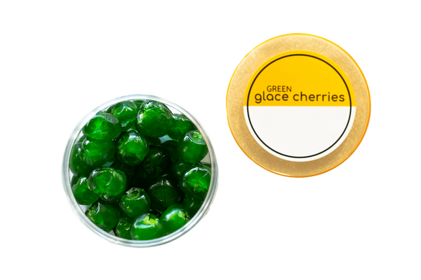 An open container of green glacé cherries