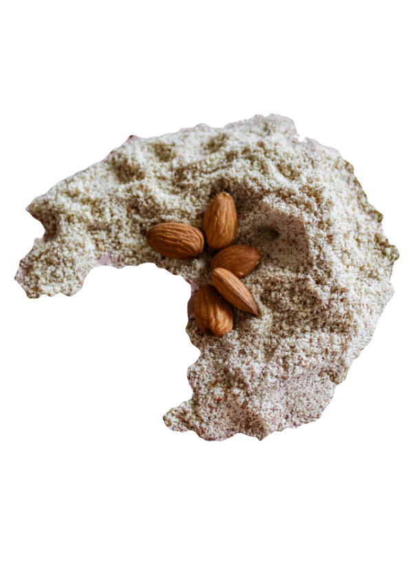 Moon shaped pile of Almond Flour with five whole raw almonds. 