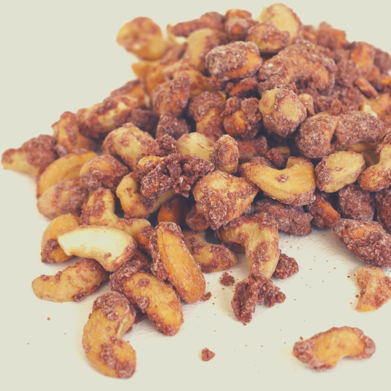 Close up of a pile of Cinnamon Roasted Cashews. 
