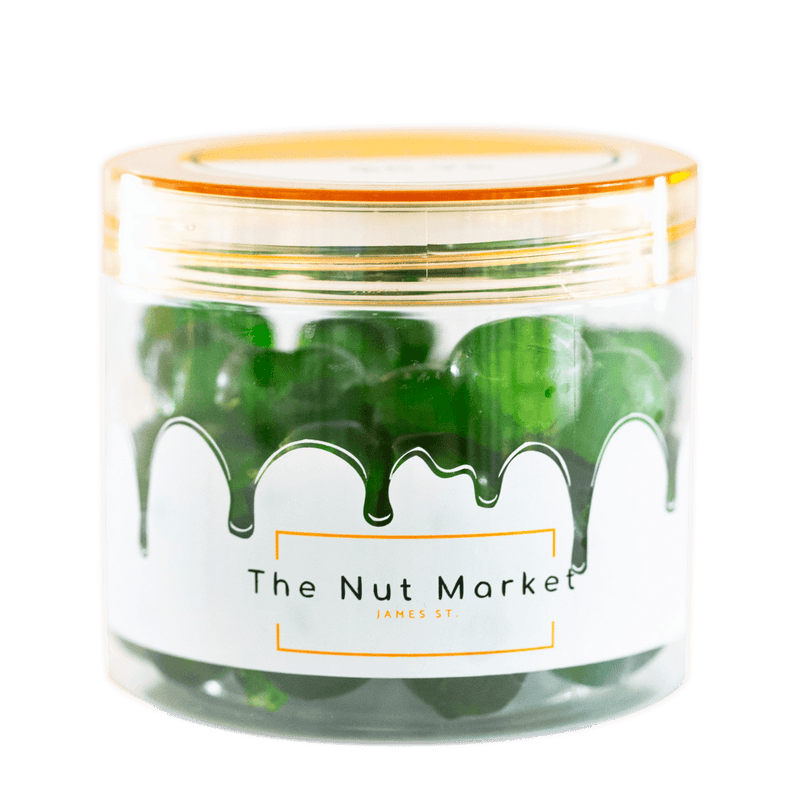 Side on view of Nut Market jar with Glace Cherries Green inside.