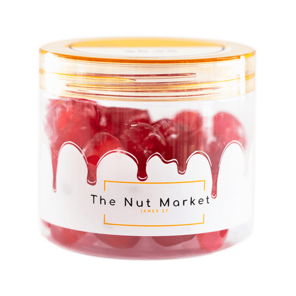 Side on view of Nut Market jar with Glace Cherries Red inside.
