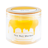 Side on view of Nut Market jar with Glace Pineapple inside.