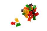 Small pile of Gummi Bears sitting next to a yellow, red and green gummy bear.