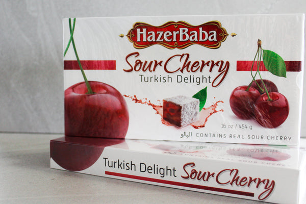 Hazer Baba Sour Cherry Turkish Delight Gift Boxes stacked together on concrete background.