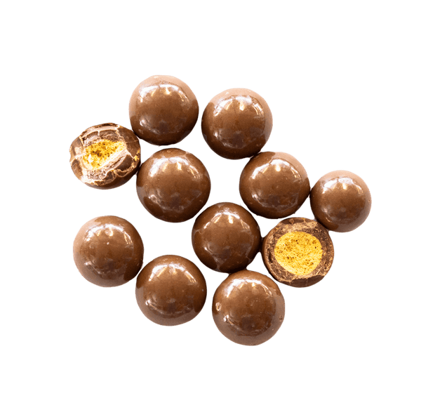 Chocolate Malt Balls scattered with some chopped open to expose crispy centre.