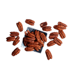 Scattered raw Pecans for sale on a square plate at The Nut Market 
