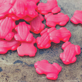 Close up of small scattered pile of Red Frogs Lollies.