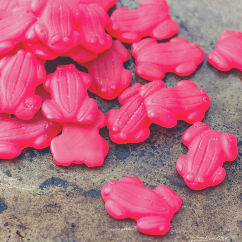 Close up of small scattered pile of Red Frogs Lollies.