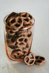 Vegan Mylk Chocolate Pretzels in tall glass on concrete background.